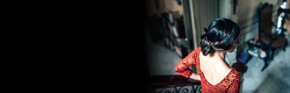 Image of a lady in red dress walking down a staircase