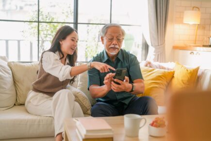 Father and daughter looking at a phone