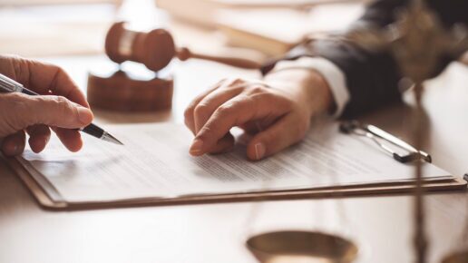 Person writing on a contract